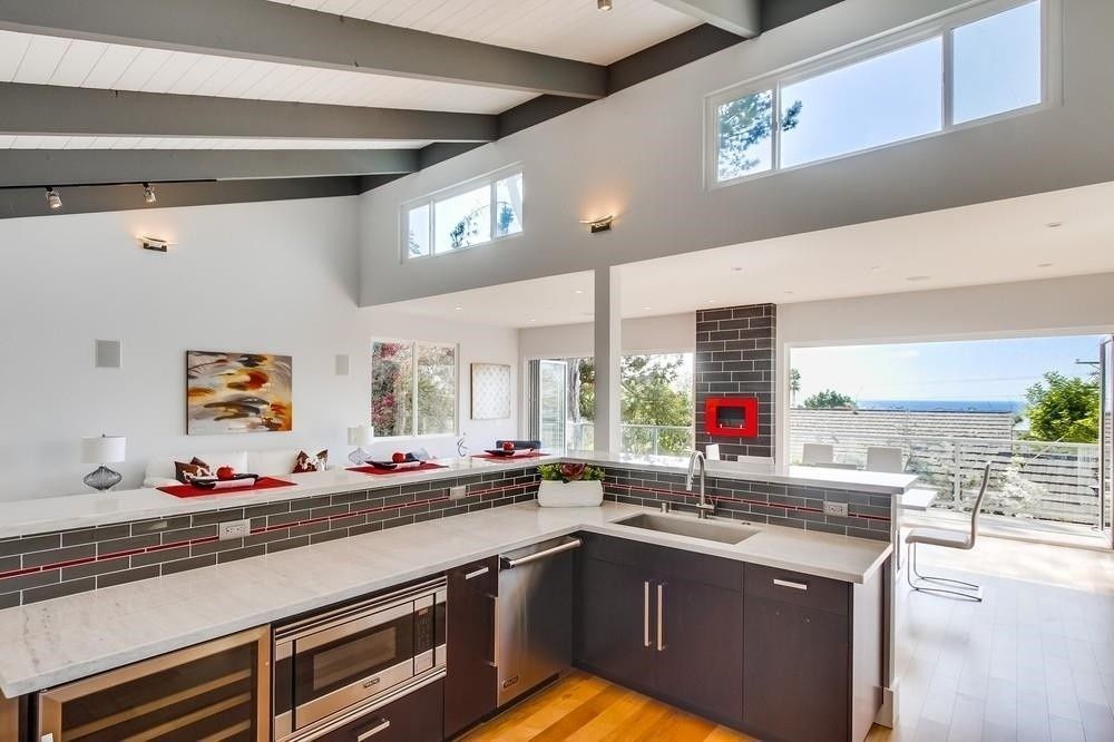 Kitchen with vaulted ceilings and sliding glass doors.