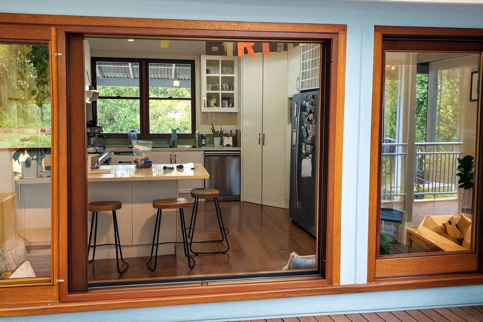 A Balcony With Sliding Glass Doors And A Table And Chairs — Screen Factory In Ocean Shores, NSW