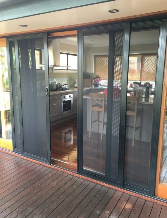 A Kitchen With Sliding Glass Doors And A Wooden Deck — Screen Factory In Billinudgel, NSW