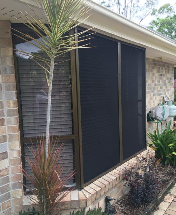 A House With A Screened In Window And A Palm Tree In Front Of It — Screen Factory In Billinudgel, NSW