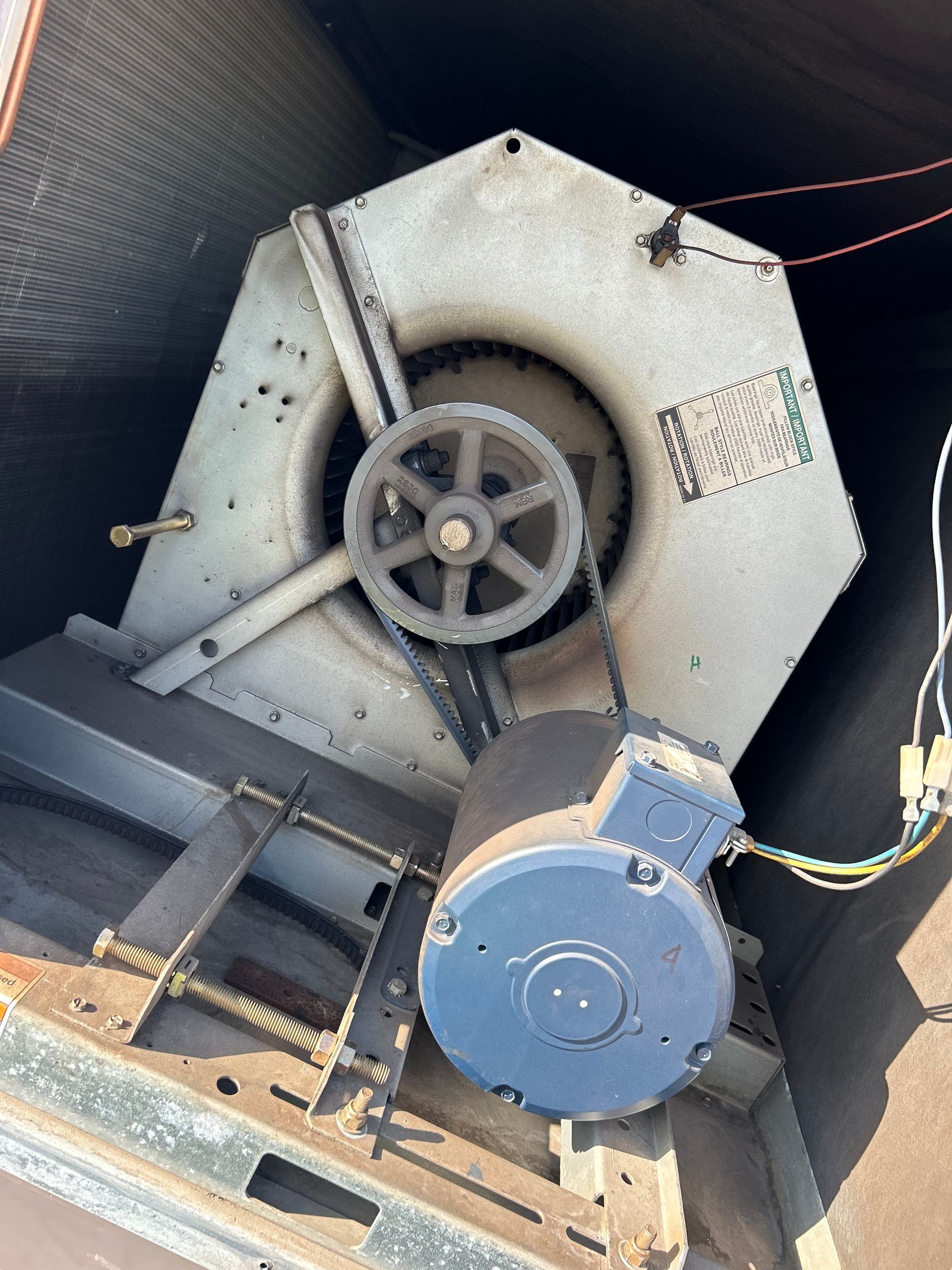 A close up of a fan with a motor attached to it.