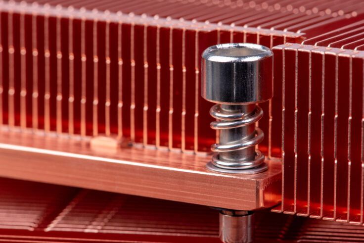 Copper CPU cooler with a spring-loaded mounting screw.