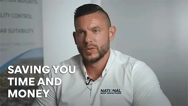 A professional speaking on camera against a branded background with the text