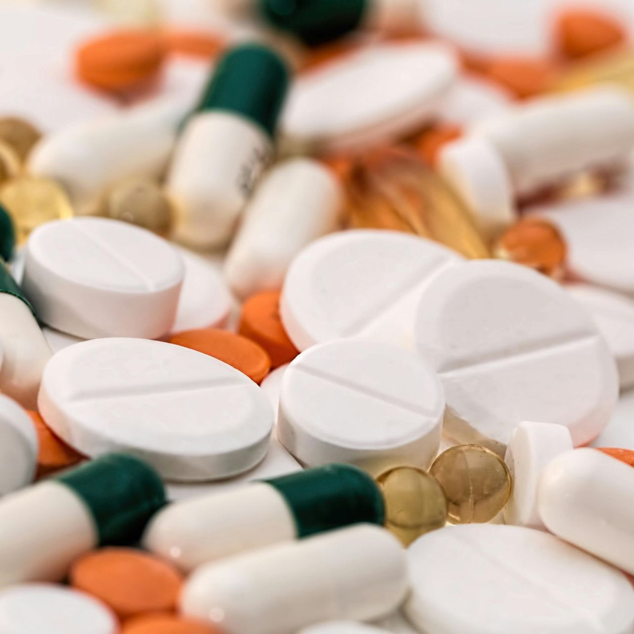 A pile of pills and capsules on a table