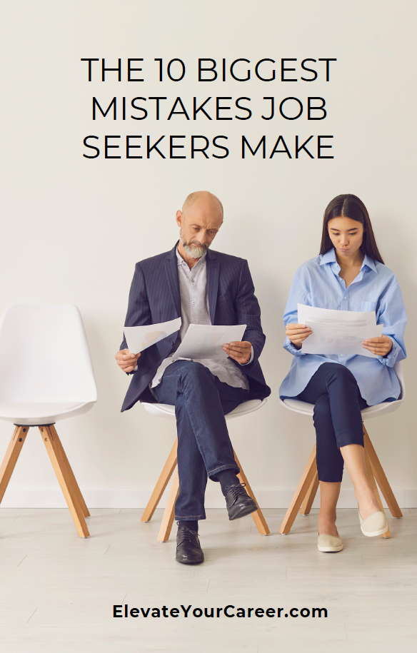 A man and a woman are sitting in chairs looking at papers.