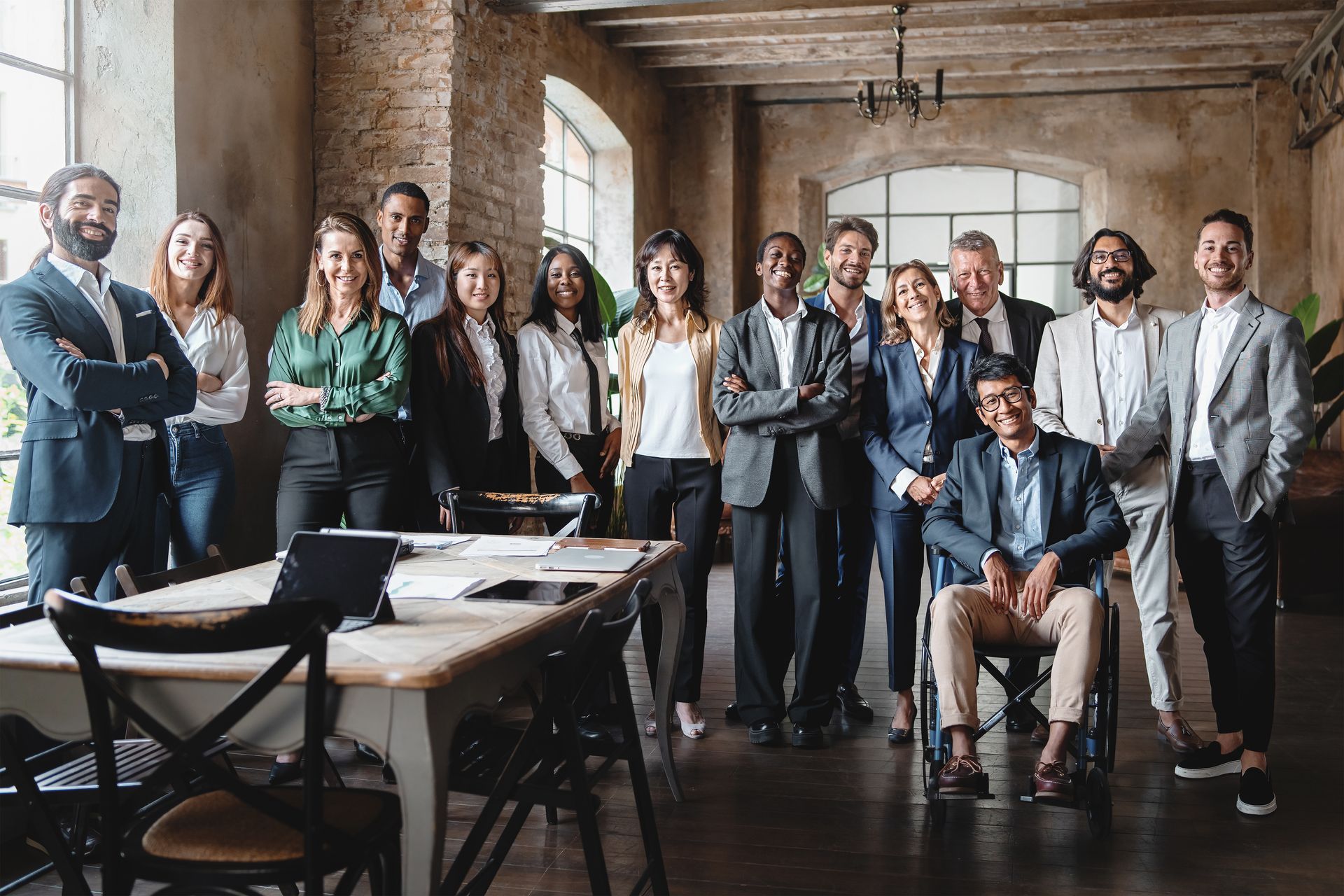 A group of business people are posing for a picture in an office.