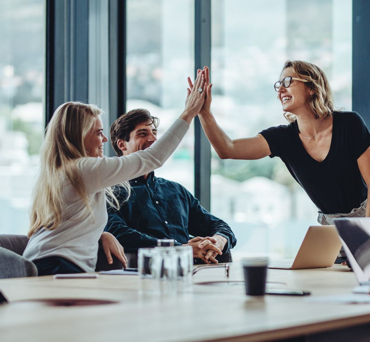 A woman is giving a presentation to a group of people in an office.