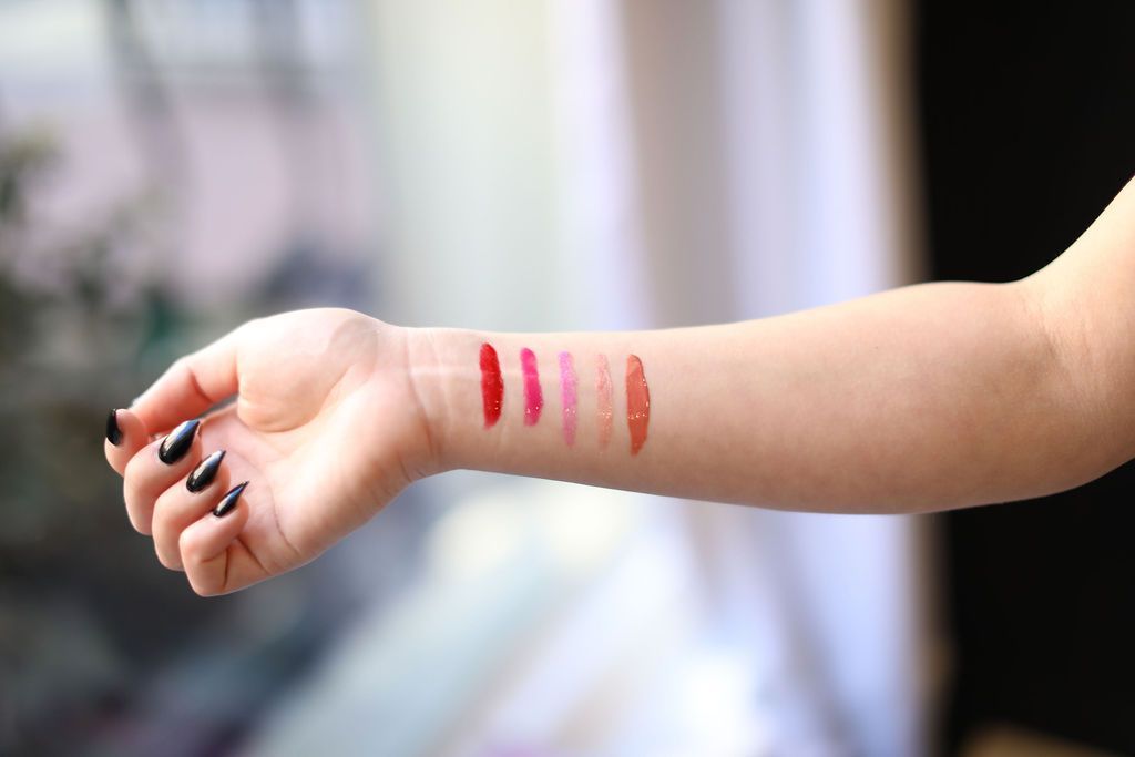 A woman 's arm with lipstick samples on it