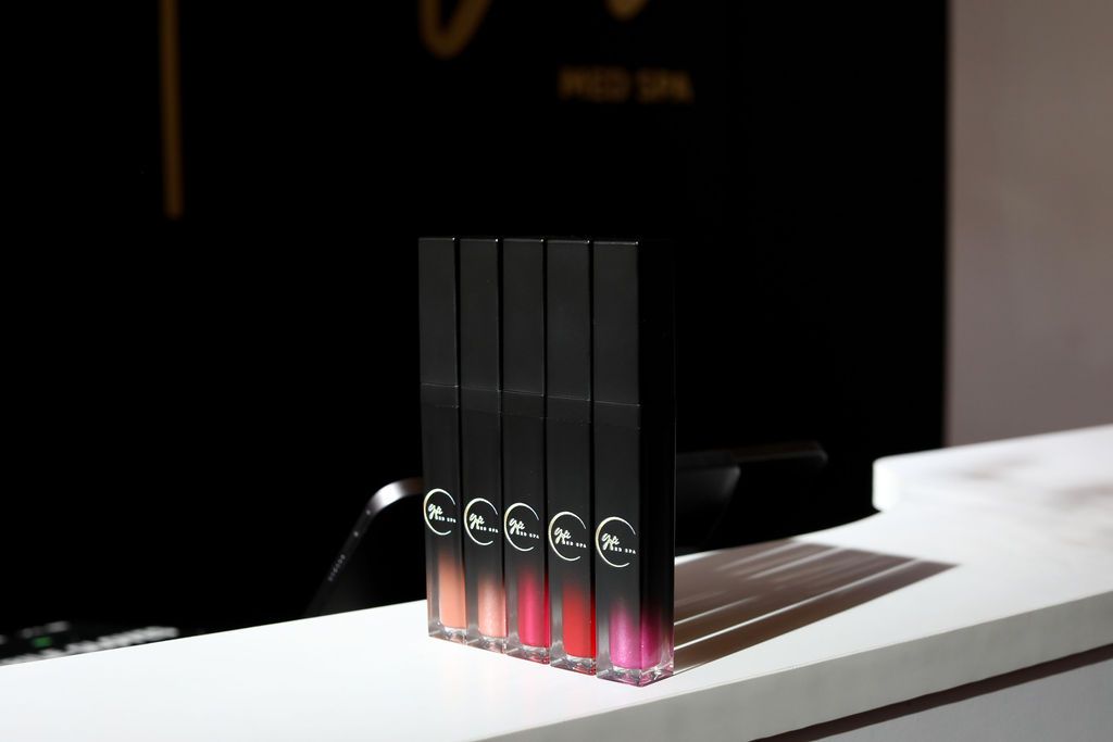 A row of lipsticks sitting on top of a white counter.