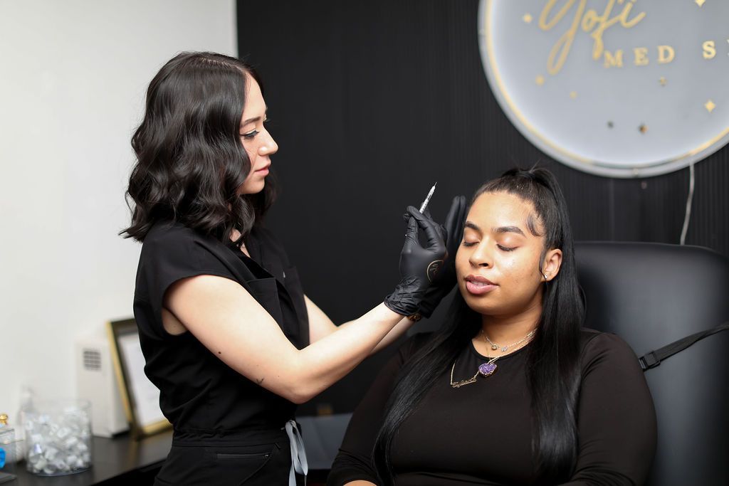 A woman is getting a botox injection in her face.