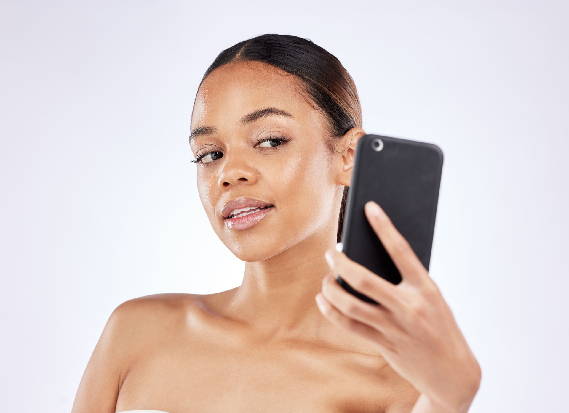 A close up of a woman 's face with her hands on it.