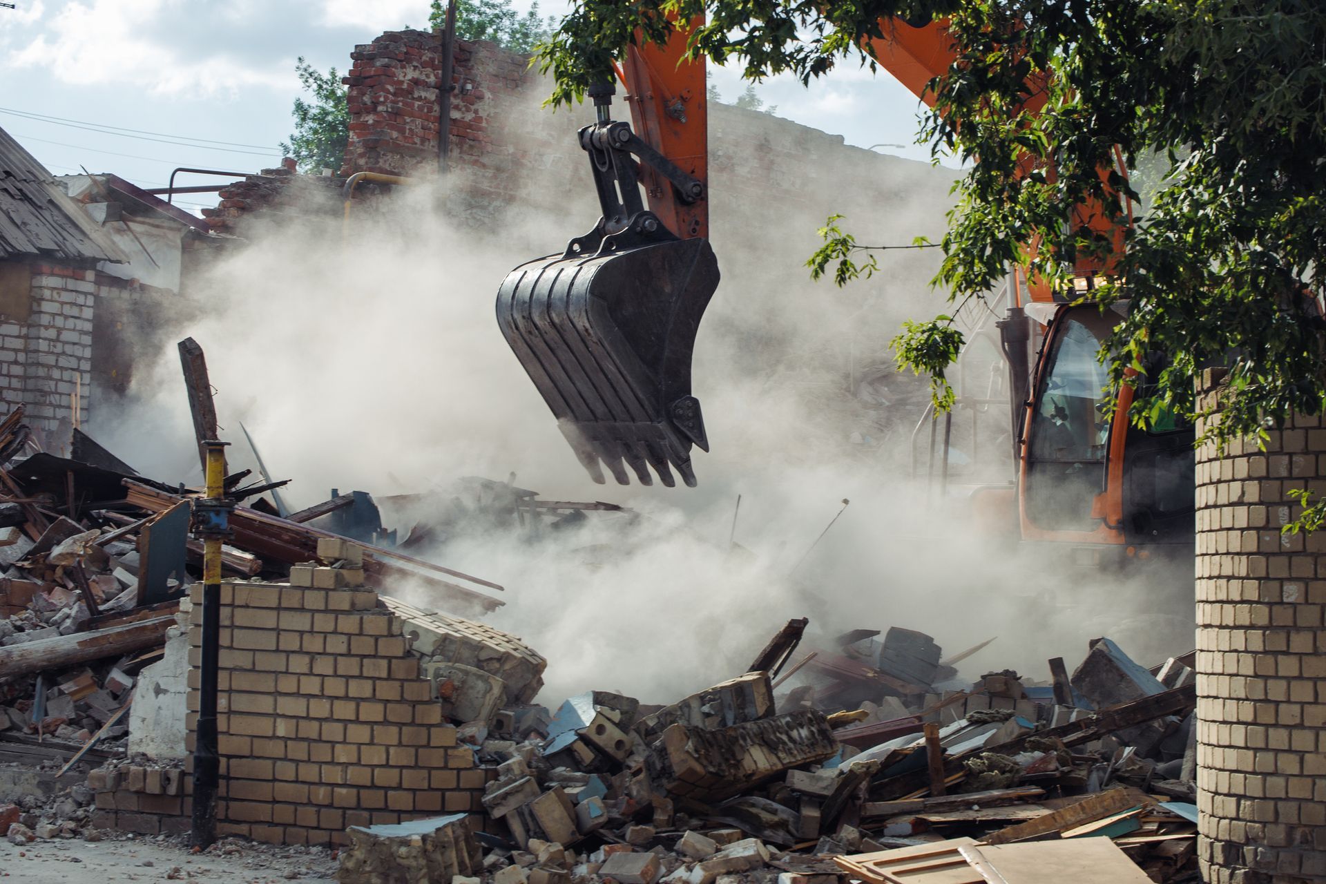 Excavator Is Demolishing a Brick Building — Bentonville, AR — Tribus Construction LLC