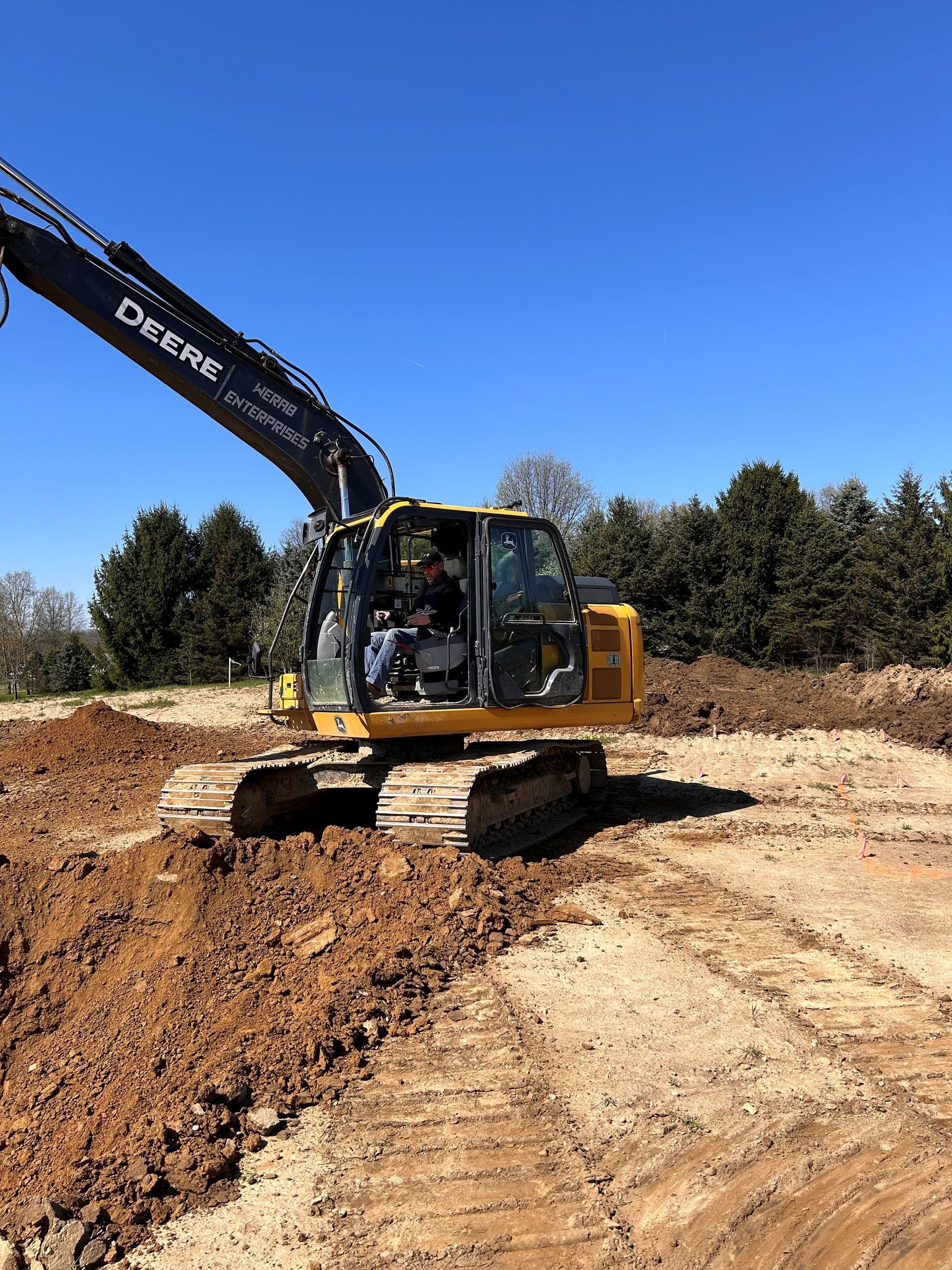 An excavator is digging a hole in the dirt. | Atwater, OH | Werab Enterprises
