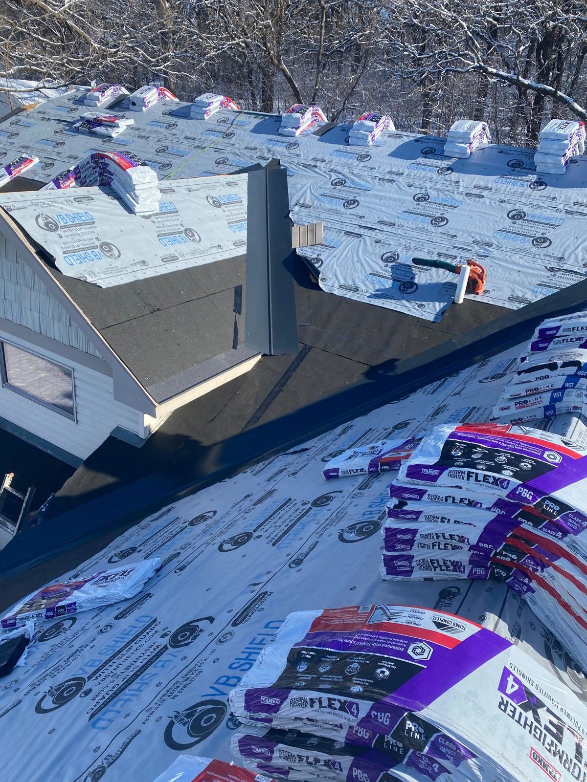 Snowy ski slope with colorful race bibs and a metal jump ramp on the course