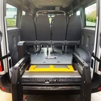 The back of a van with a lift in the back.