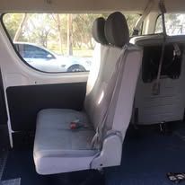 There are two seats in the back of a van.