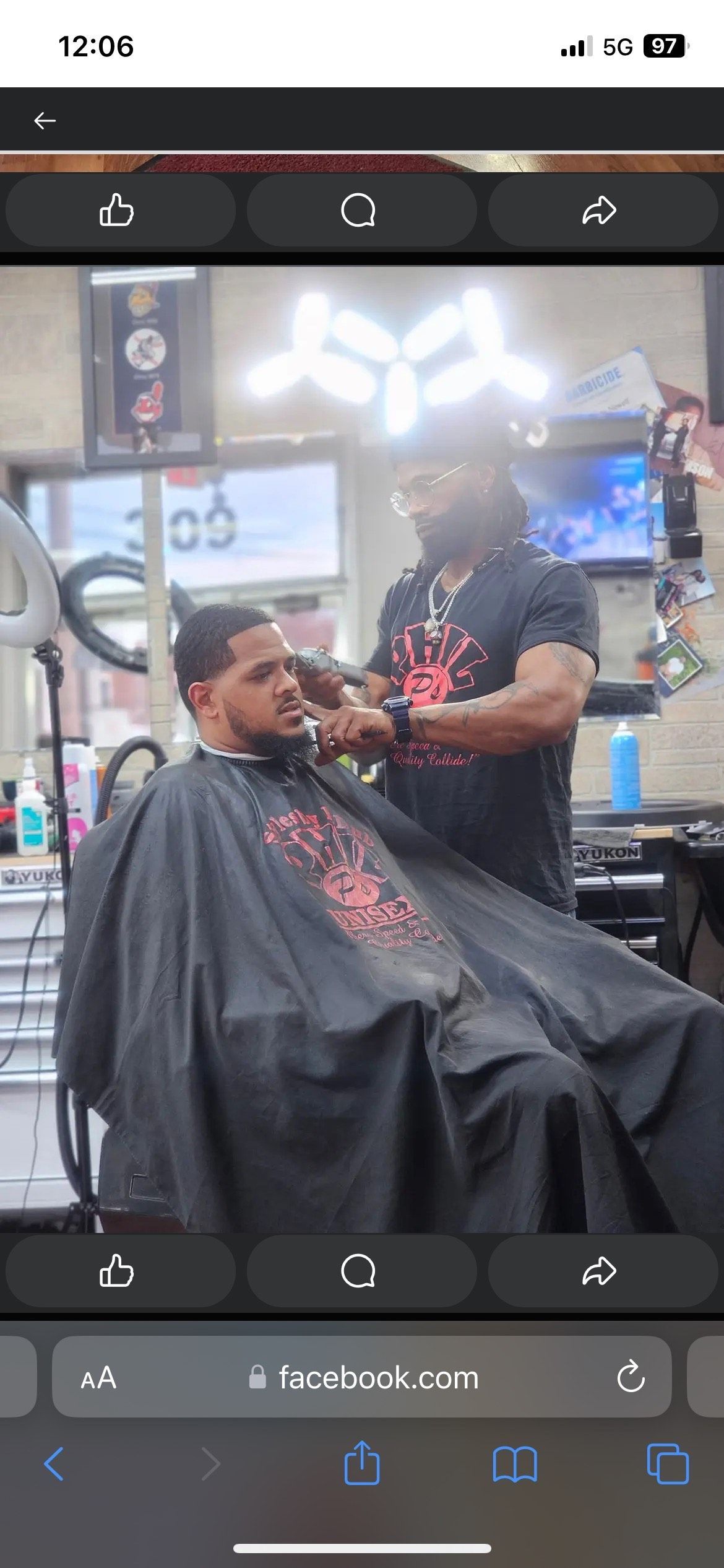 A man is getting his hair cut at a barber shop.
