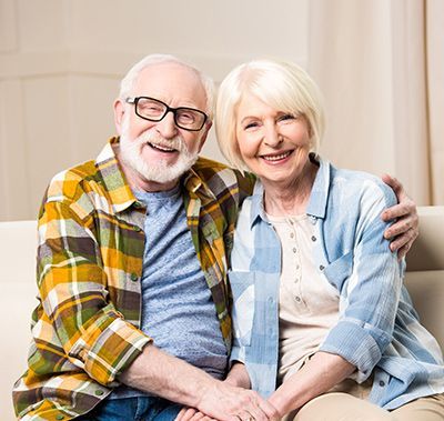 A man and a woman are sitting on a couch.