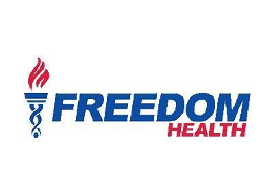 The logo for freedom health has a torch and a medical symbol.
