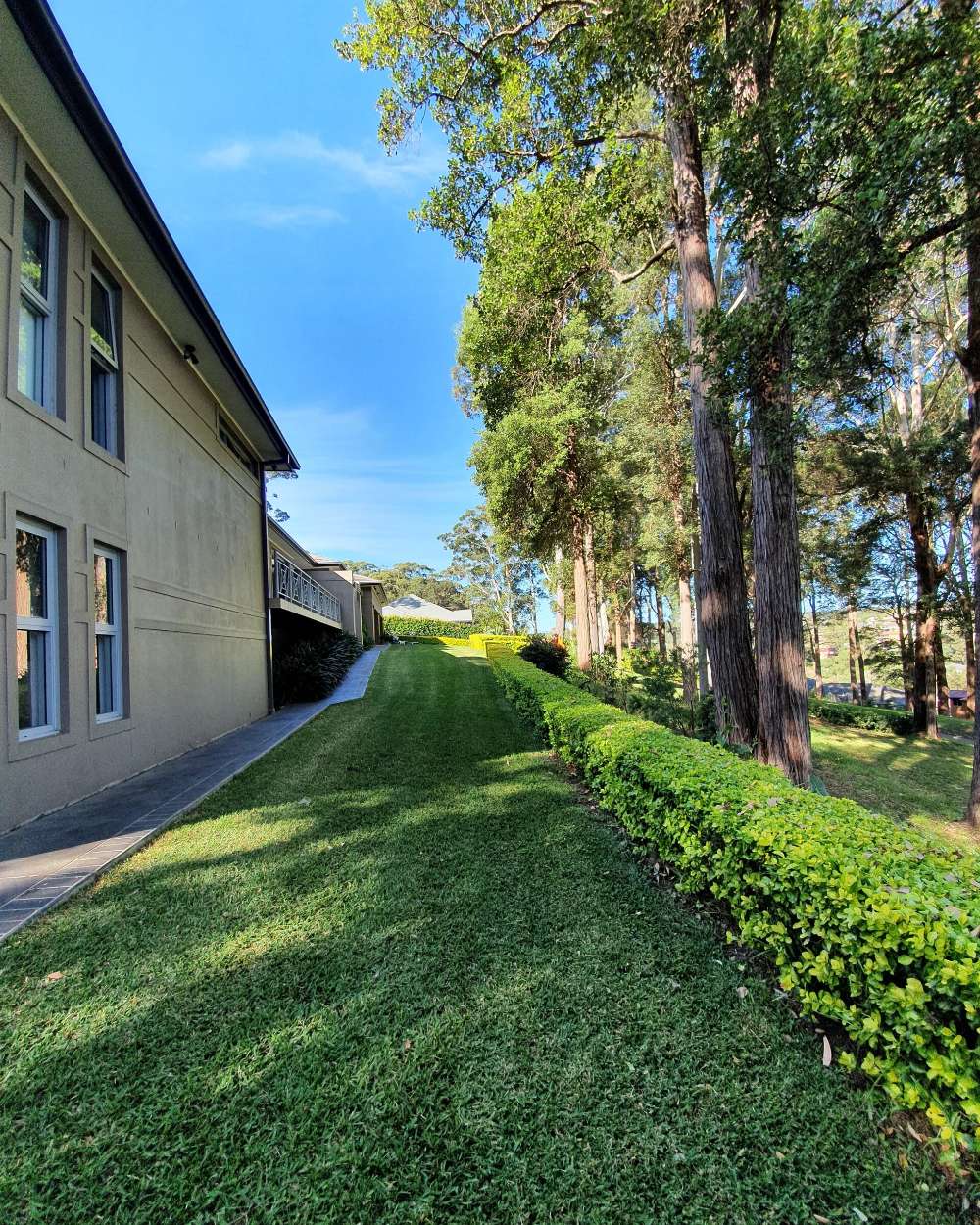 House with Green Lawn in the Backyard — Landscaping inspiration in Matcham, Central Coast