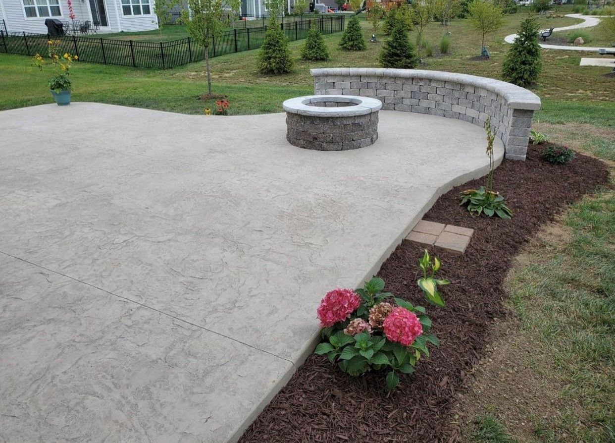 Stylish bricked wall in garden, featuring a textured and well-designed surface.