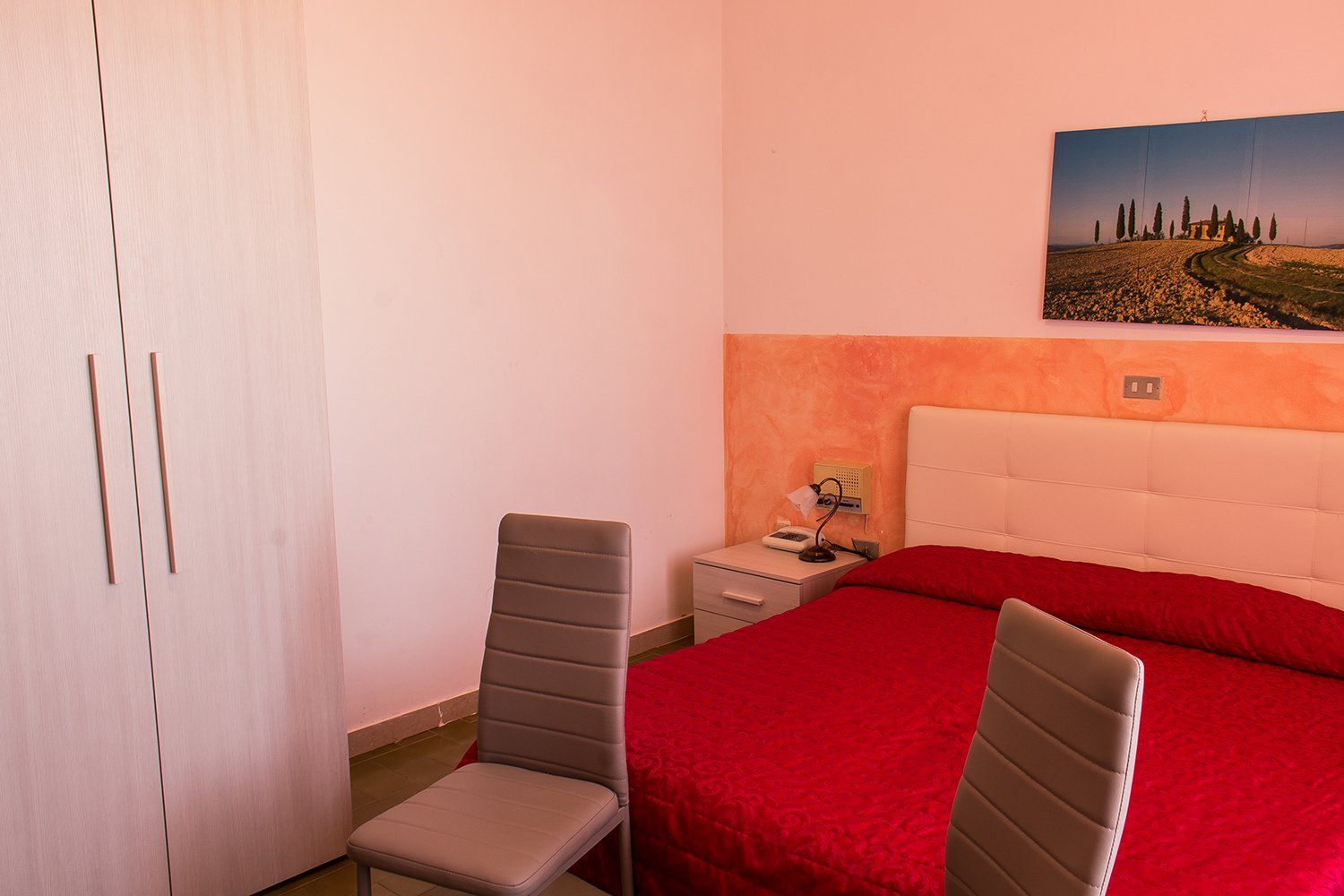 hotel room with bed and chairs