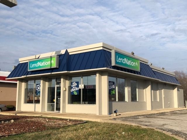 LendNation storefront with blue roof, green sign, and large windows.
