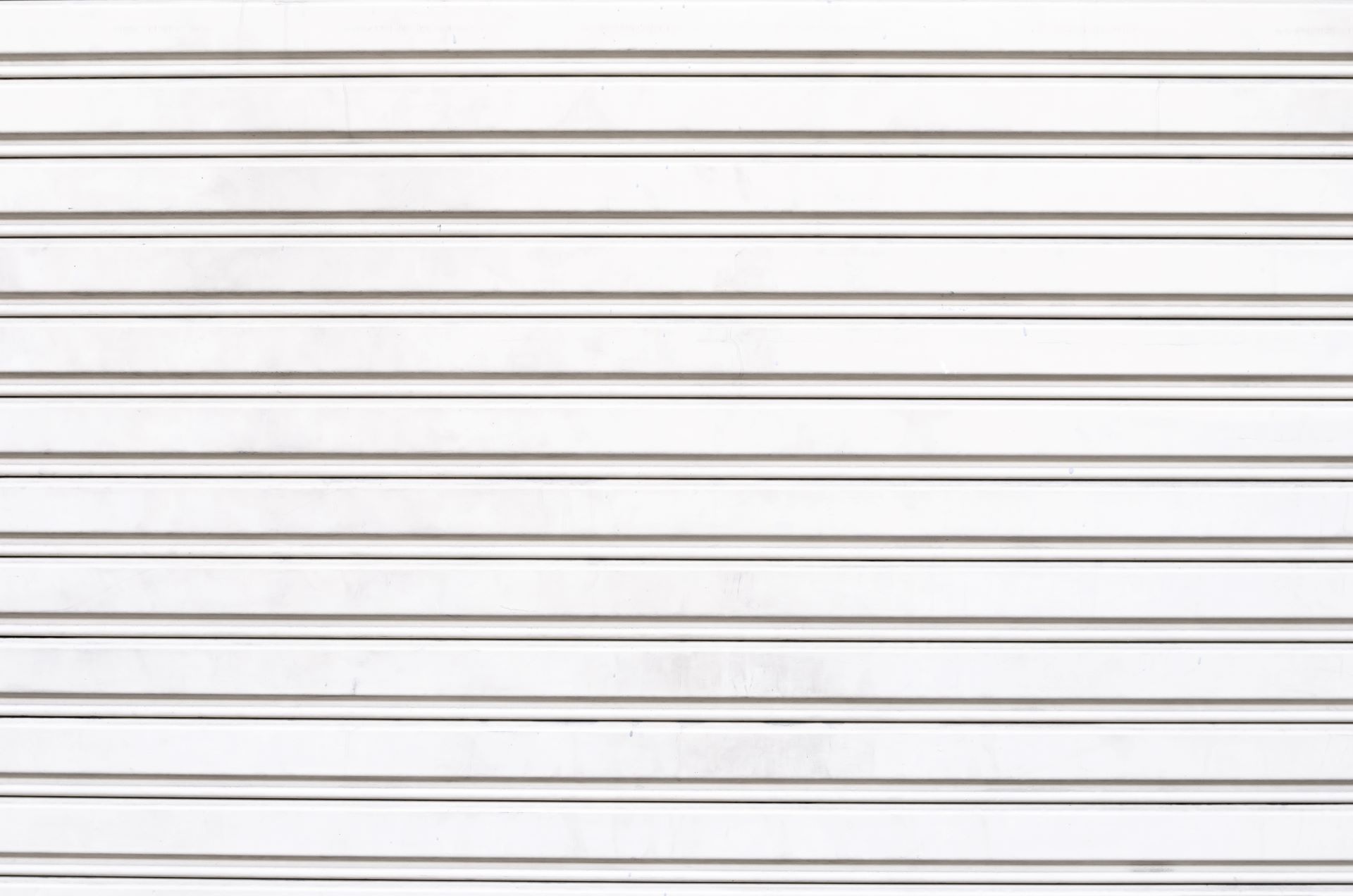 White metal roll-up door, horizontal lines.