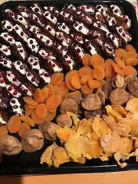 A tray of dried fruits and nuts on a table