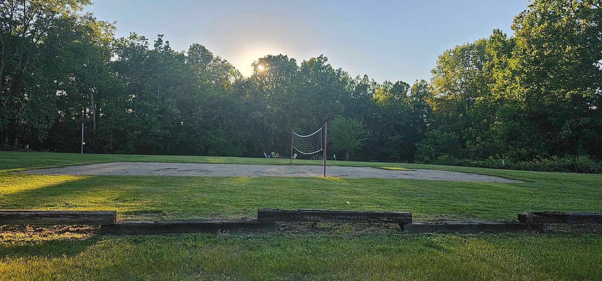 a volleyball net is in the middle of a grassy field
