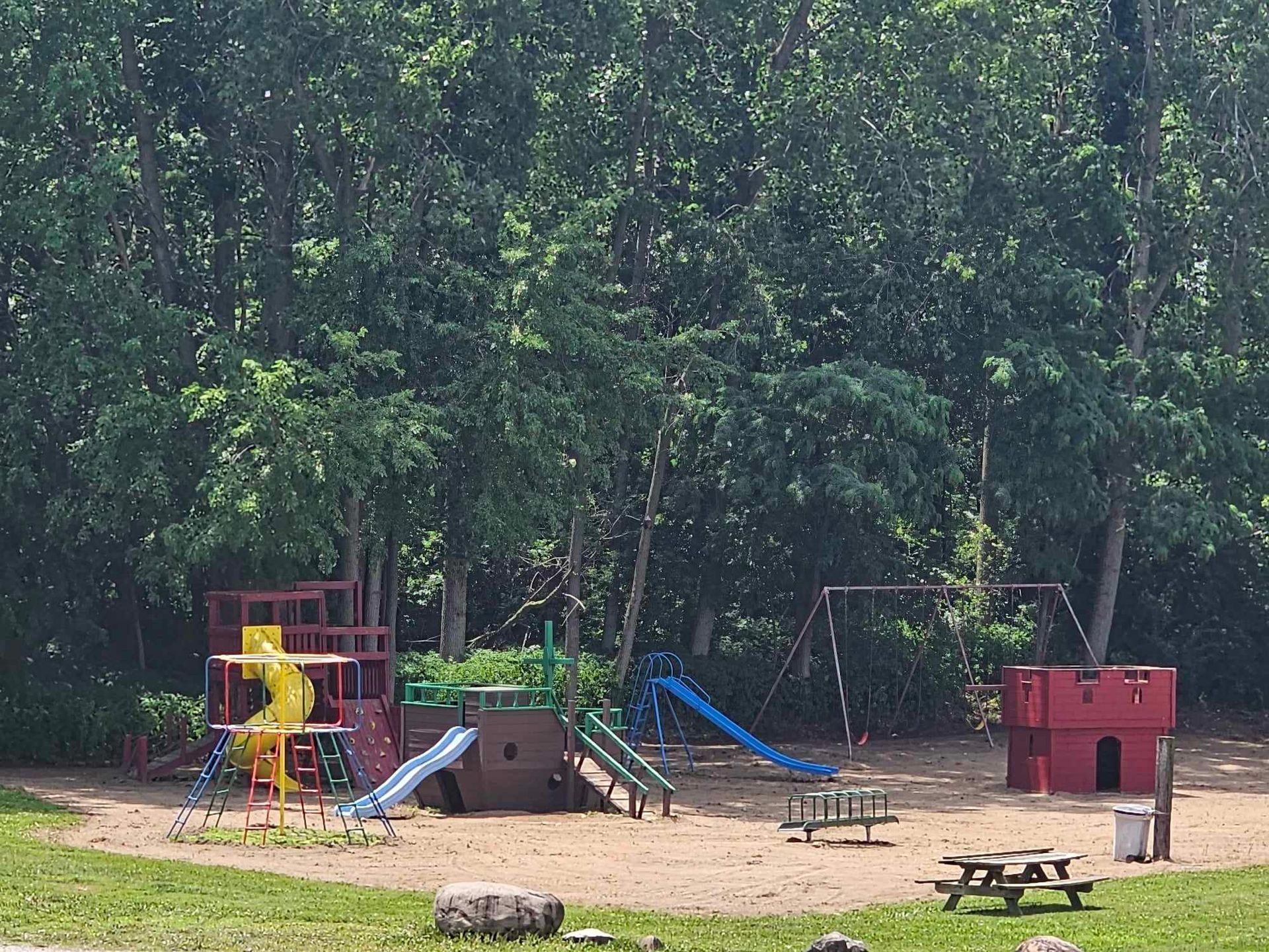 a playground with a castle in the middle of it