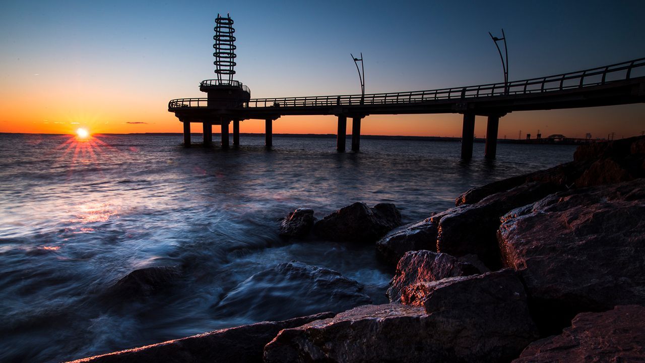 A pier overlooking a body of water at sunset