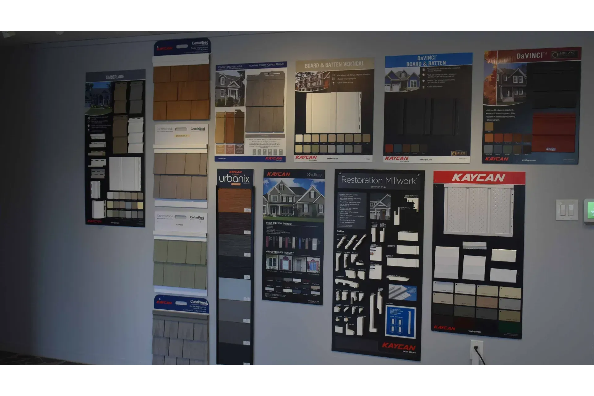 Wall displays showcasing various building material samples and product options.