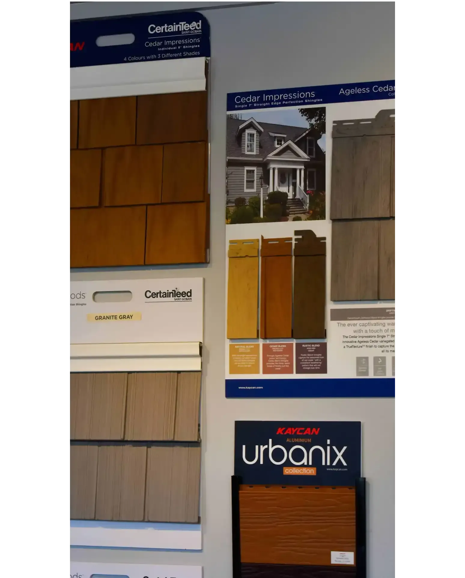 Wall display of roofing and siding samples in various colors.