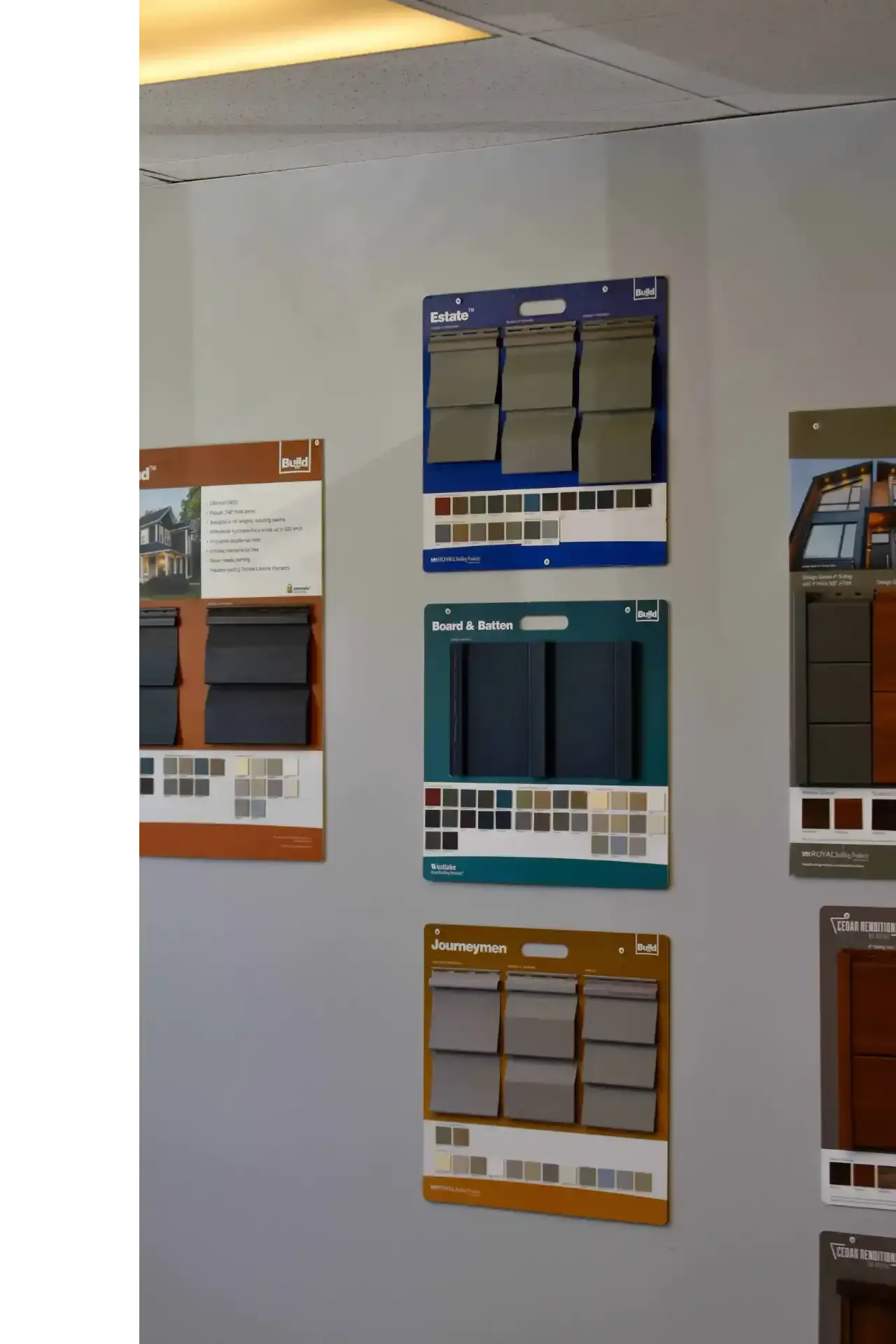 Color sample displays on a wall, showcasing shades of gray, blue, and brown.