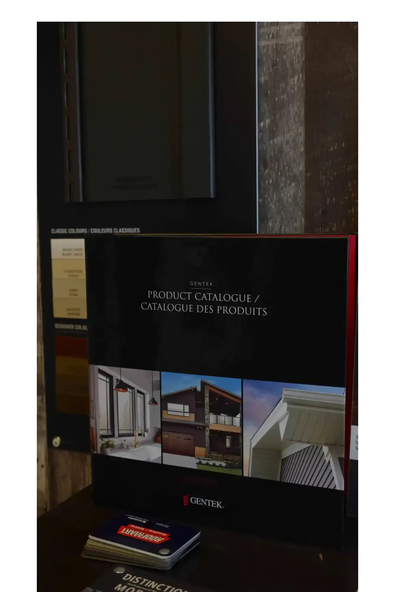 Brochure and samples on a dark surface, possibly at a home design showroom.