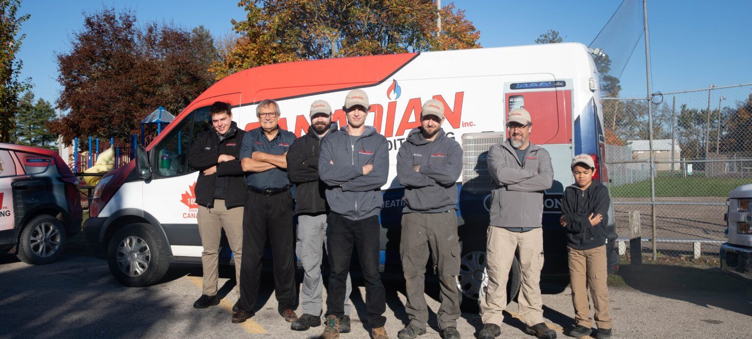 A group of men are standing in front of a van.