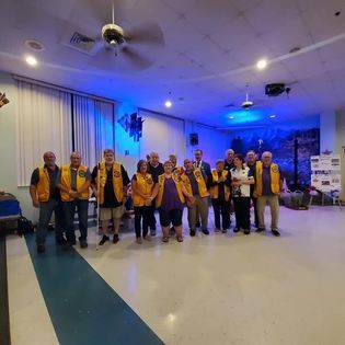 A group of people are posing for a picture in a room.