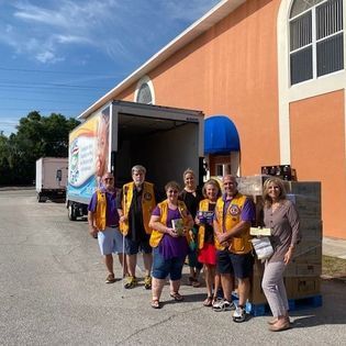 A group of people are posing for a picture in front of a building.