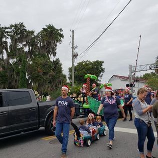 A group of people are walking down the street in a parade.