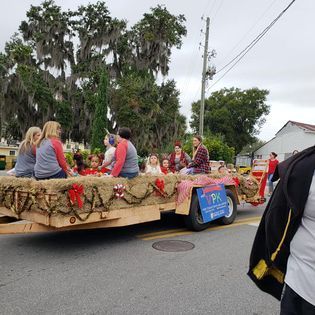 A group of people are riding on a float in a parade.