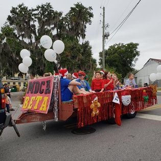 A group of people are riding in a float in a parade.