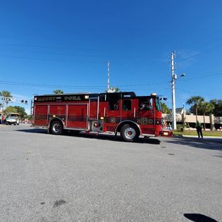 A red fire truck is parked on the side of the road.