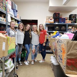 A group of young women are posing for a picture in a store.