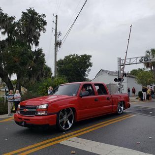 A red truck is parked on the side of the road