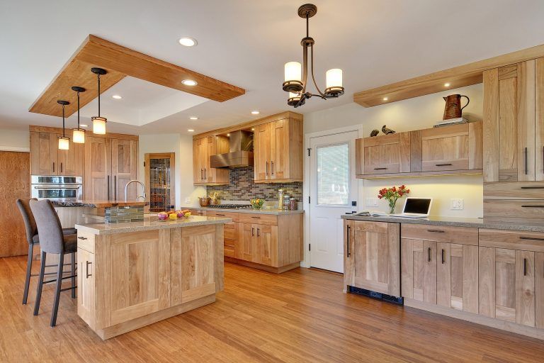 A kitchen with wooden cabinets and a large island.