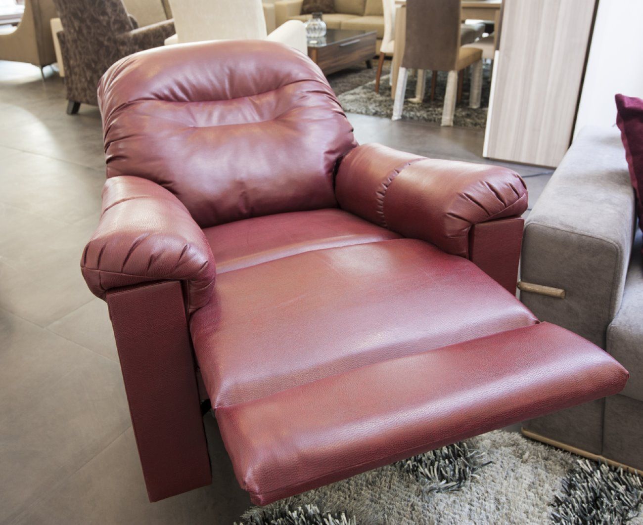 A Red Leather Recliner Is Sitting On A Rug In A Living Room — Ocean Charm Upholstery In Southport, QLD