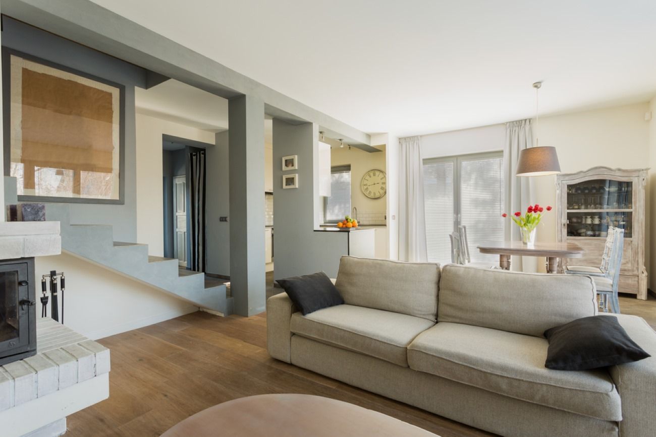 A Living Room With A Couch, Fireplace And Stairs — Ocean Charm Upholstery In Southport, QLD