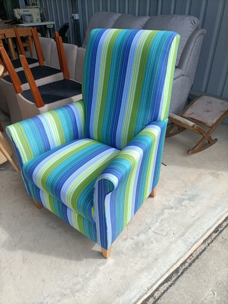 A Blue And Green Striped Chair Is Sitting On A Cement Floor  — Ocean Charm Upholstery In Southport, QLD