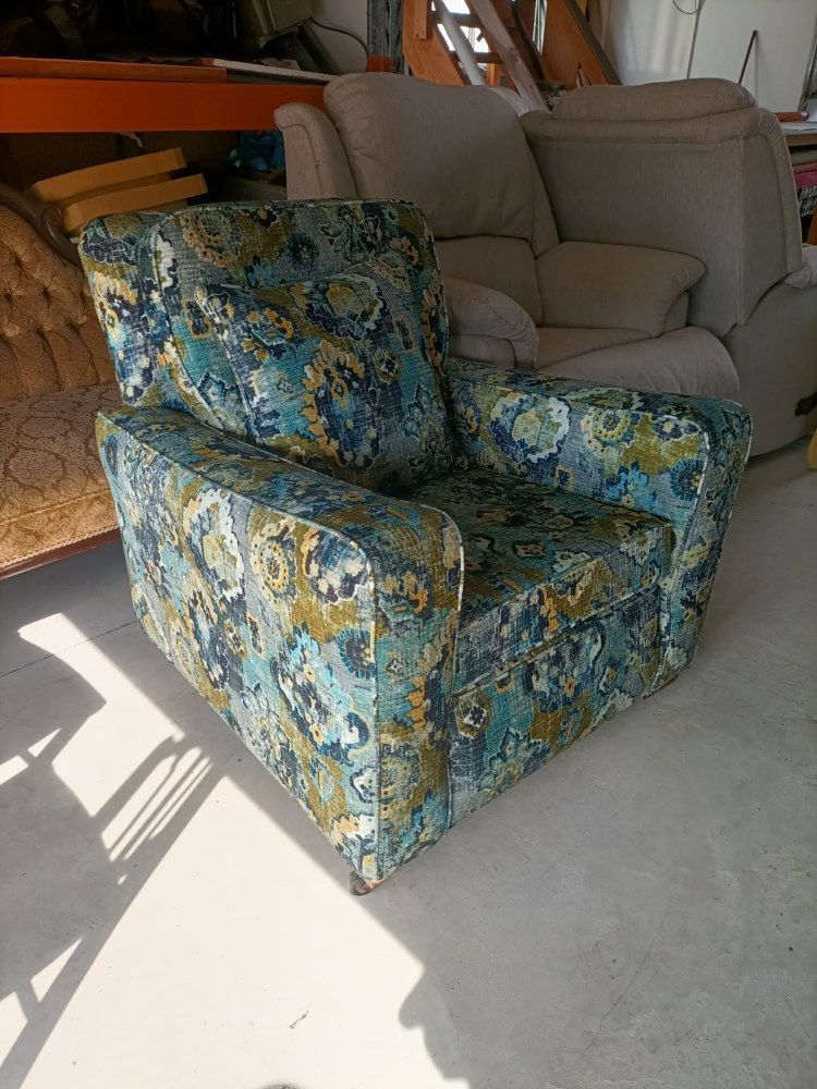 A Chair With A Floral Pattern Is Sitting In A Room Next To A Couch  — Ocean Charm Upholstery In Southport, QLD